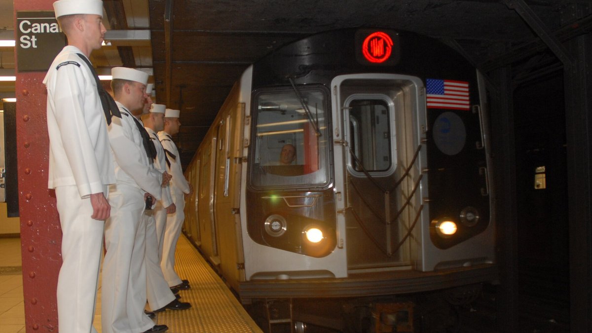 A subway train pulling into the Canal Street station in Manhattan as riders wait on the platform