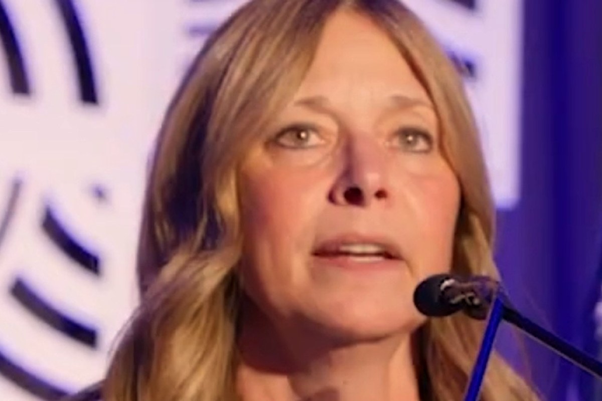 Amy Acton speaking at a lectern during a 2025 conference