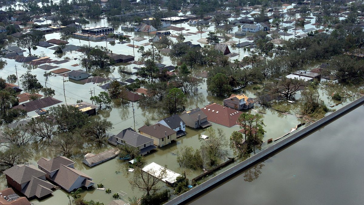 Aerial view of a flooded neighborhood, with houses surrounded by water