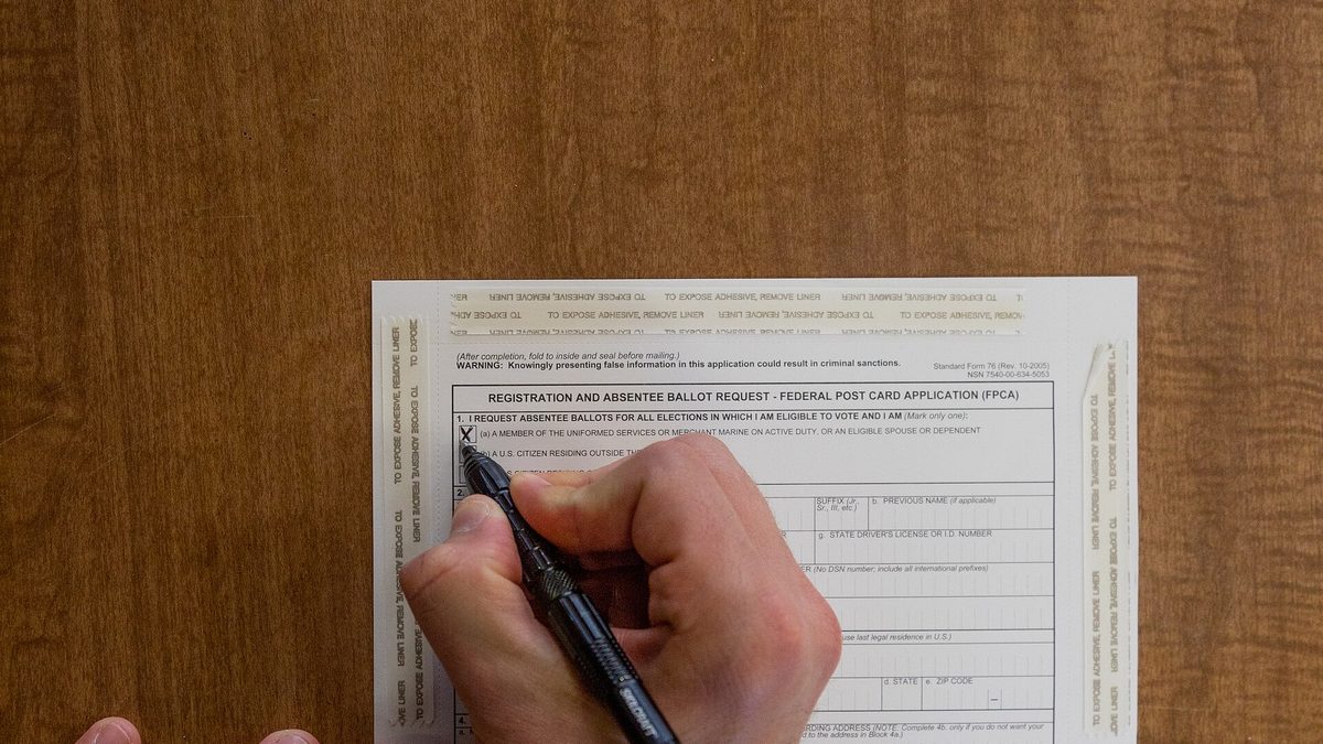 New York National Guard soldiers filling out federal ballot application forms while deployed